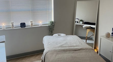 Tranquil massage room at Massage by Lucie, Northwich, England, GB with a cozy table and calming decor.