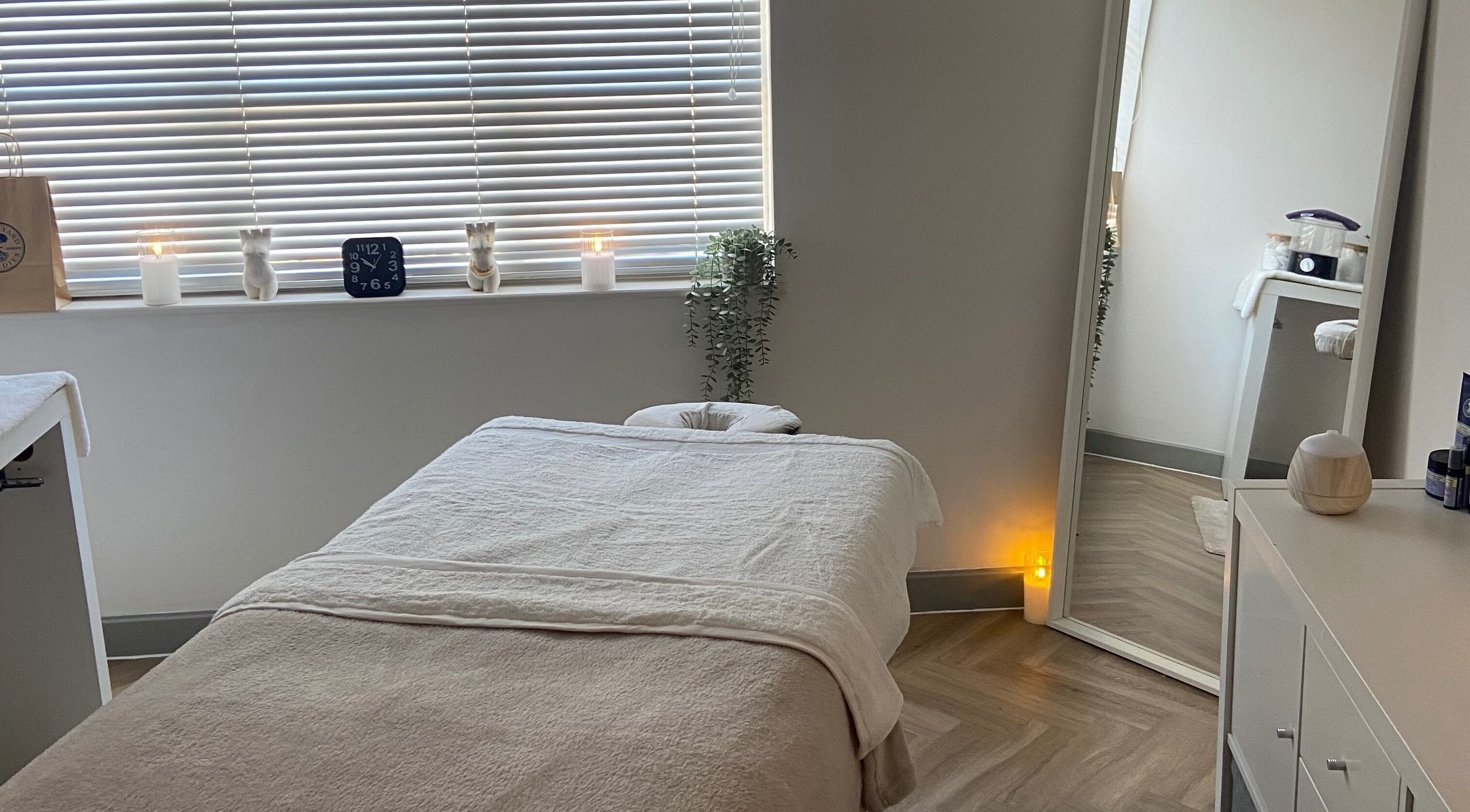 Peaceful massage room at Massage by Lucie, Northwich, England, GB with soft lighting and cozy bed.