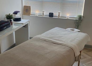 Peaceful massage room at Massage by Lucie, Northwich, England, GB with a cozy table and ambient lighting.