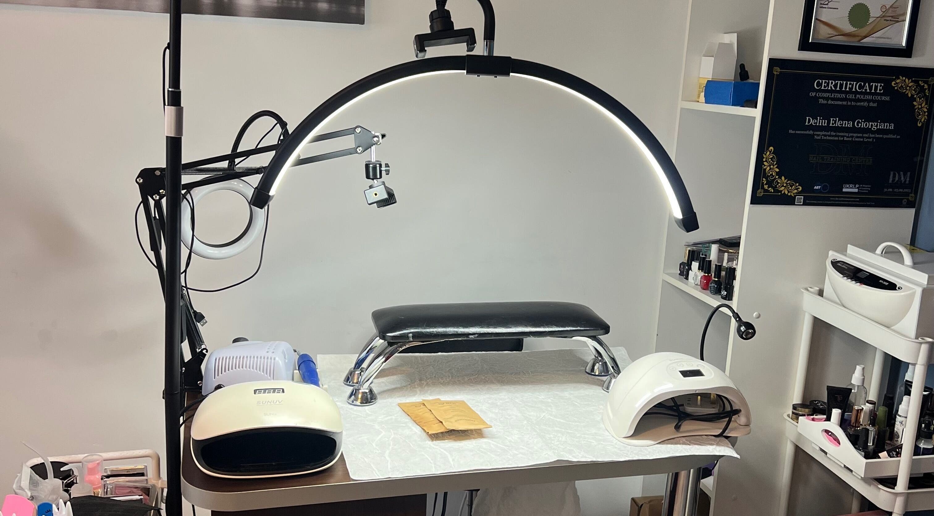 Nail station at Nova Elle Beauty, Lutterworth, England, GB with manicure tools and lamps.