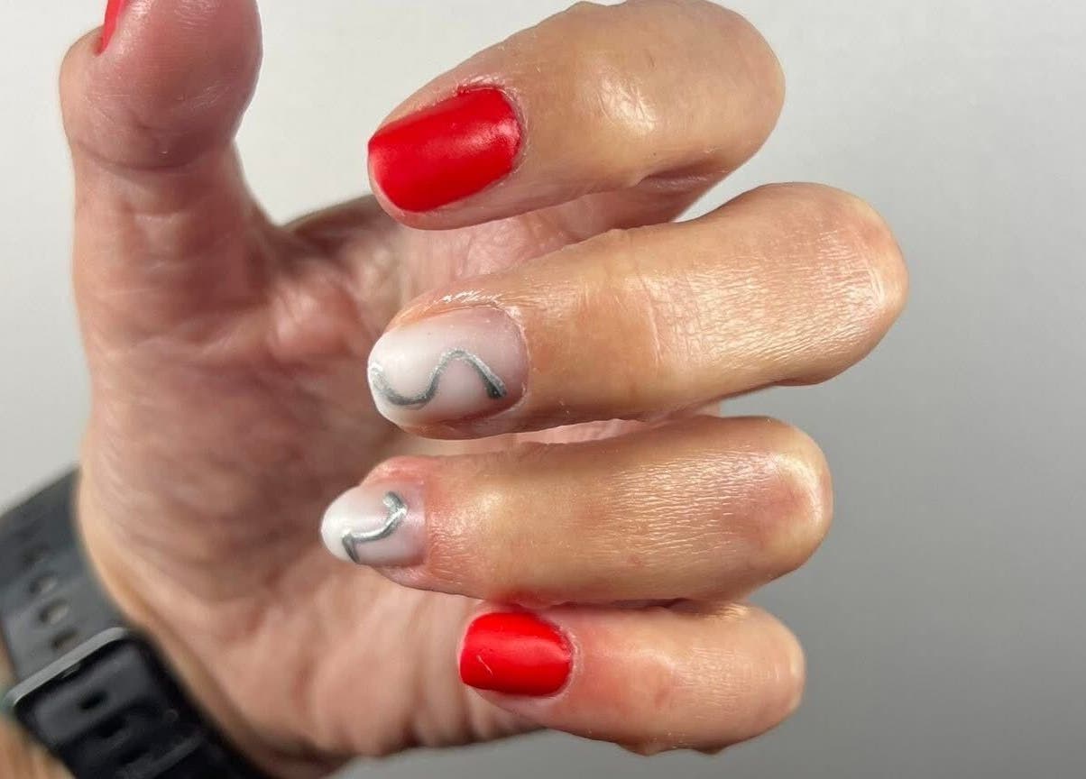 Red and artfully designed nails at Nova Elle Beauty, Lutterworth, England, GB.