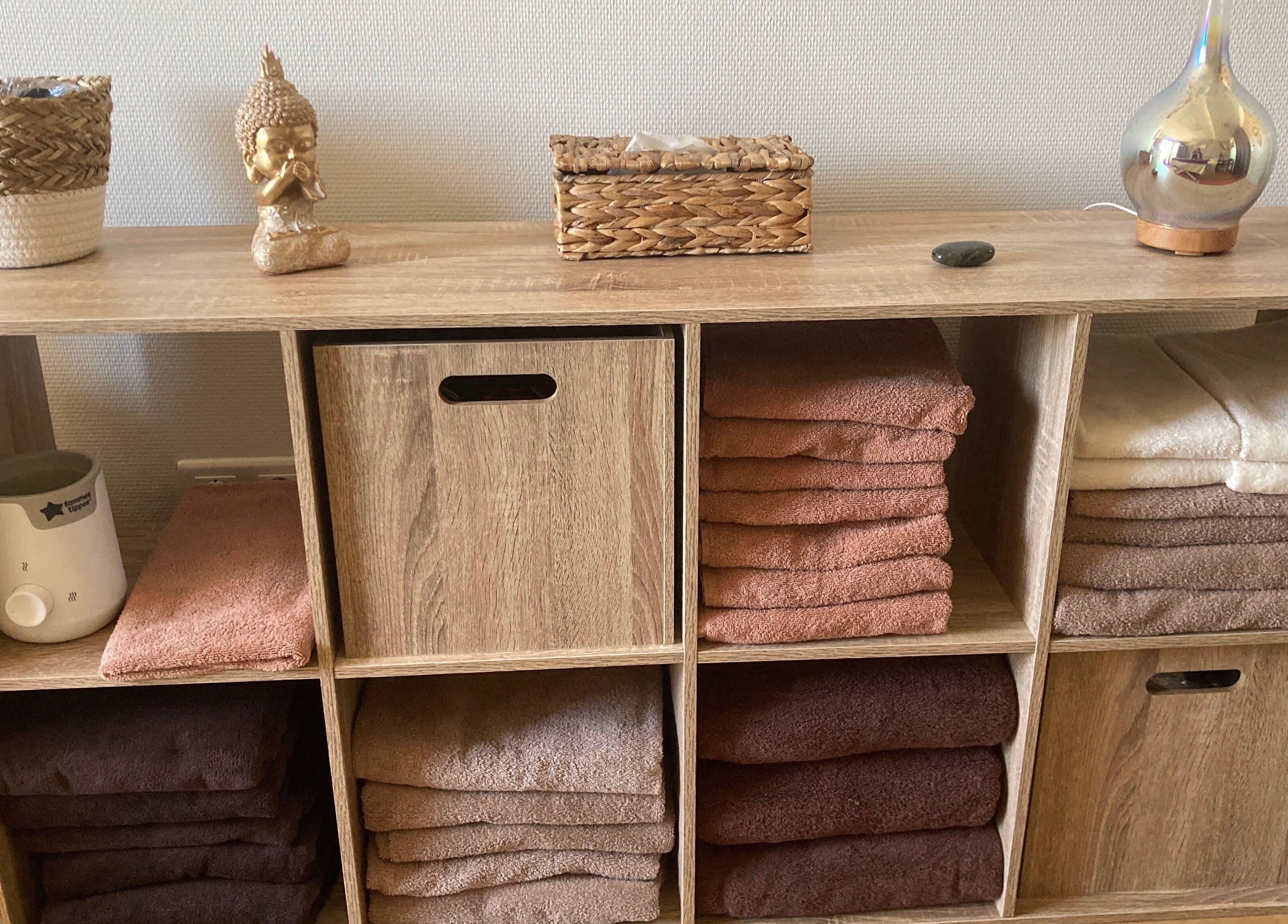 Étageres en bois avec serviettes et déco zen à Ô’tant Pour Soi, Perpignan, Occitanie, FR.