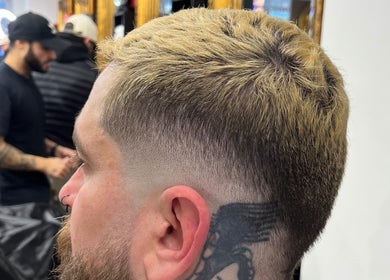Trendy short fade haircut at Cutsbyraff, Dublin, County Dublin, IE, highlighting expert technique.