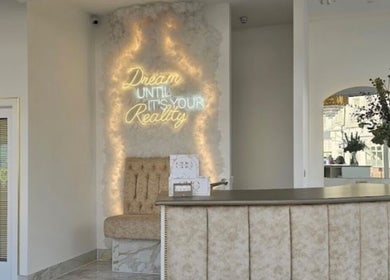 Elegant lobby with neon sign at By Chrissie Beauty, Bournemouth, England, GB.