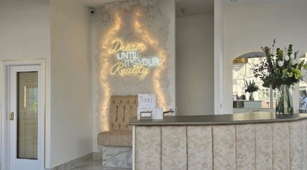 Elegant lobby with neon sign at By Chrissie Beauty, Bournemouth, England, GB.