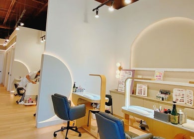 Modern beauty station at H Head Spa Wellness in Richmond Hill, Ontario, CA with sleek chairs and nail polish displays.