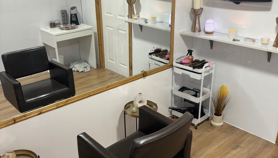 Modern styling area at Hair by Preston, Taunton, England, GB with sleek chair, mirror, and beauty tools.