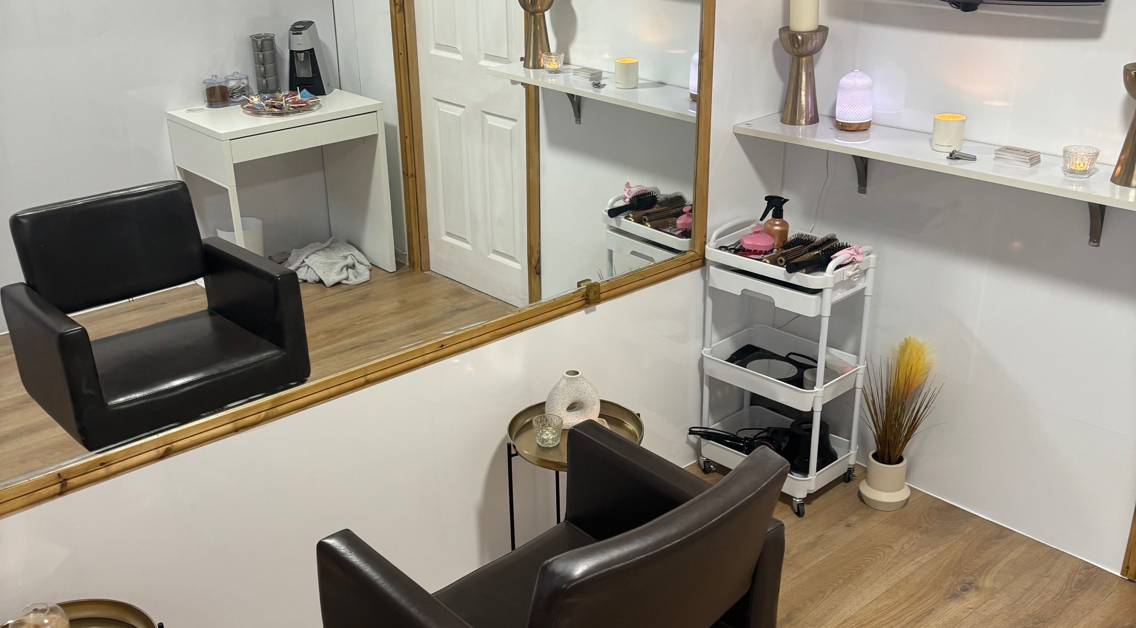 Modern styling area at Hair by Preston, Taunton, England, GB with sleek chair, mirror, and beauty tools.