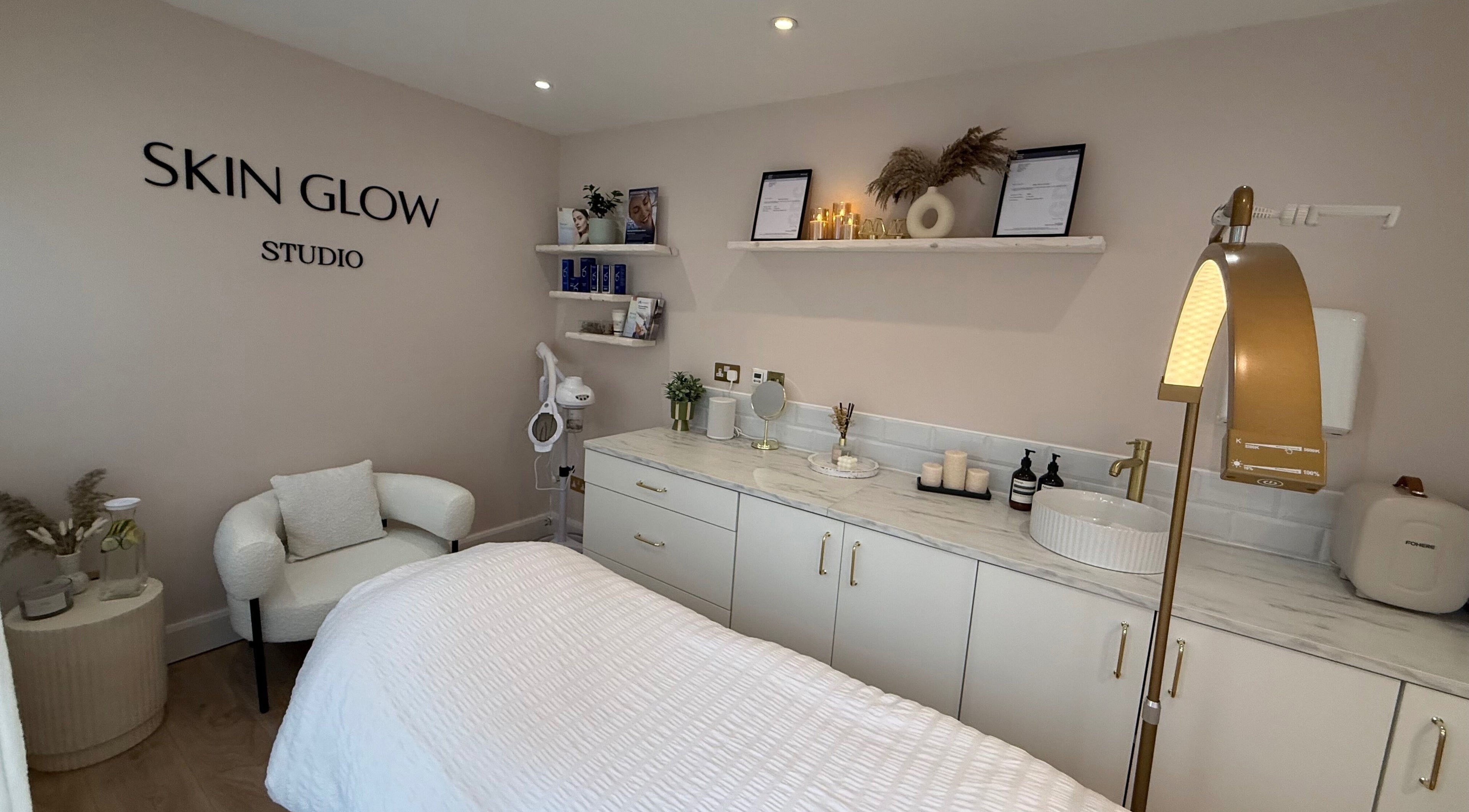Relaxing treatment room at Skin Glow Studio, Beaconsfield, England, GB, featuring modern decor and plush furnishings.