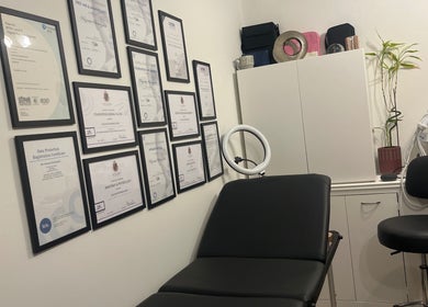 Treatment room at Naz Aesthetics in Manchester, England, GB showcasing certificates on the wall.