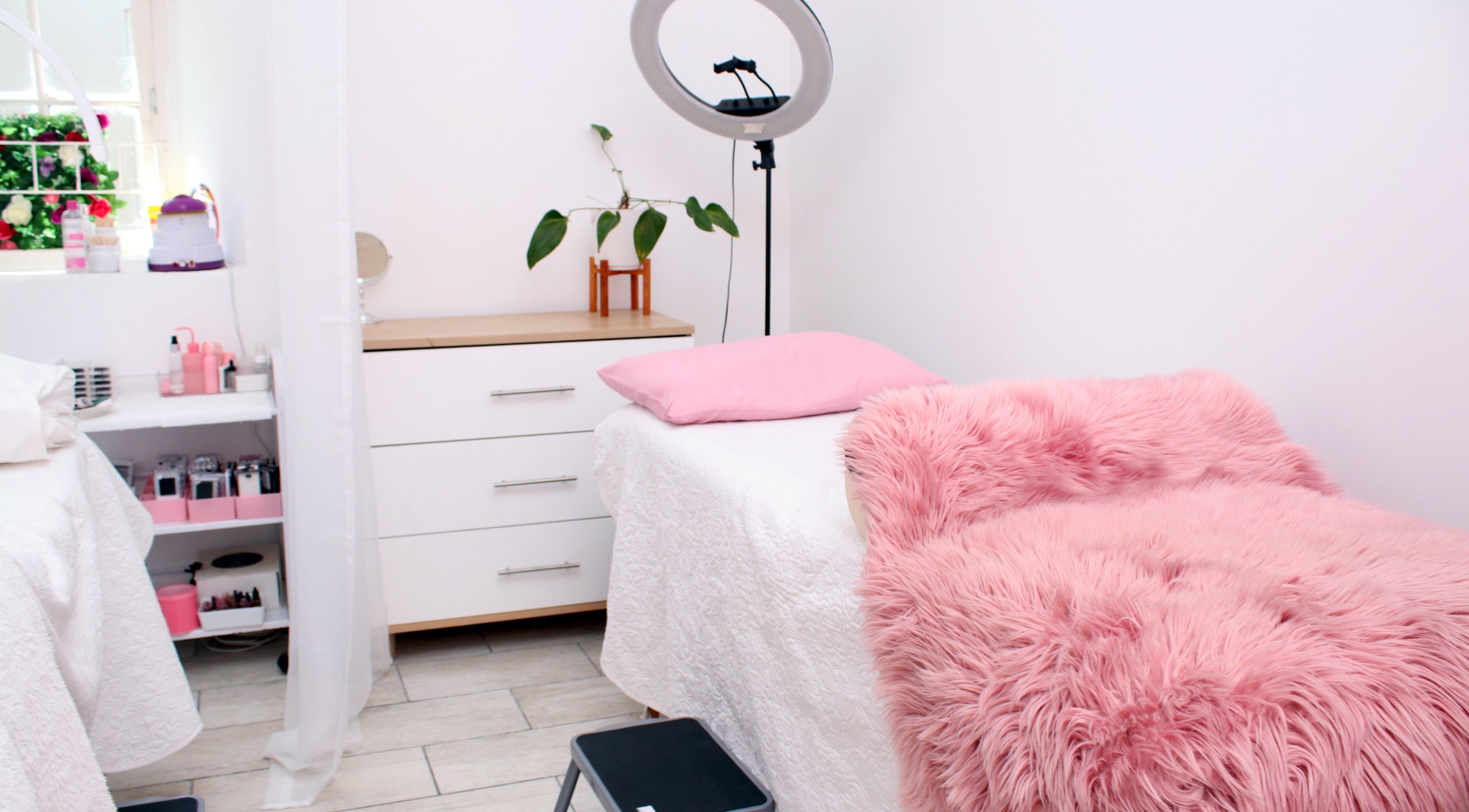 Cozy treatment room at The Beauty Vault, Paarl, Western Cape, ZA, with a pink plush blanket and ring light.
