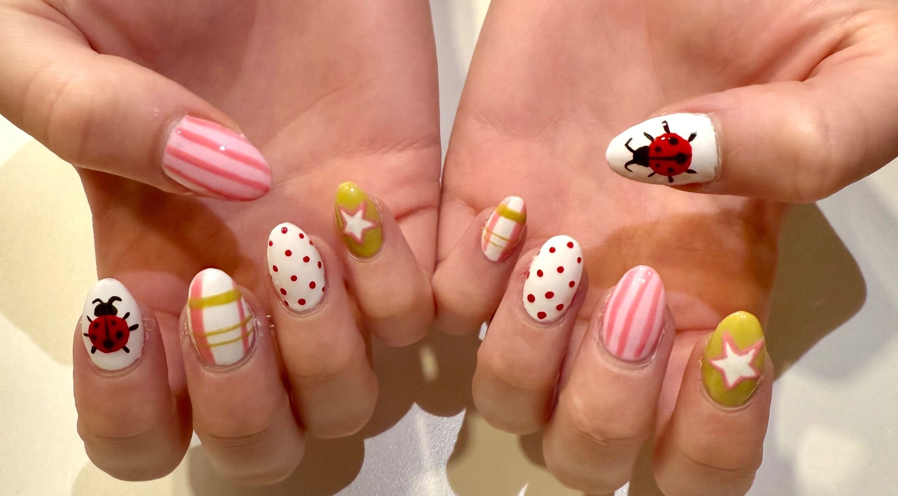 Colorful nail art with ladybugs and stripes by Melia Nailed It, Tucson, Arizona, US.