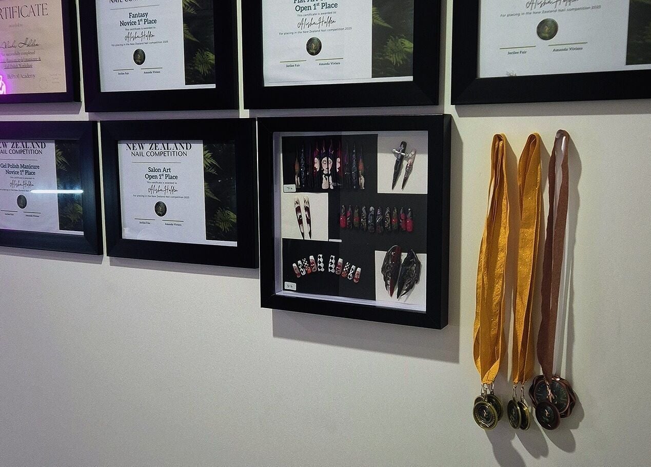 Certificates and medals at Straight Up Nails, Auckland, Auckland, NZ, showcasing achievements in nail artistry.