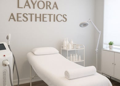 Relaxing treatment room at LAYORA AESTHETICS, Toronto, Ontario, CA with a comfortable spa bed and equipment.