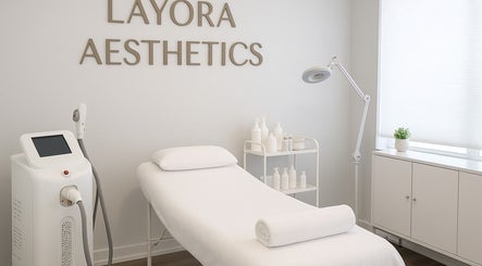 Serene treatment room at LAYORA AESTHETICS, Toronto, Ontario, CA, featuring a bed and skincare equipment.