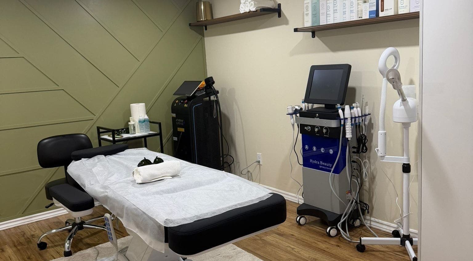 Treatment room at LAYORA AESTHETICS, Toronto, Ontario, CA, equipped with a spa bed and modern skincare devices.