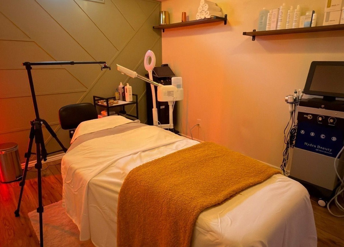 A relaxing treatment room at LAYORA AESTHETICS, Toronto, Ontario, CA, featuring a massage bed and beauty equipment.
