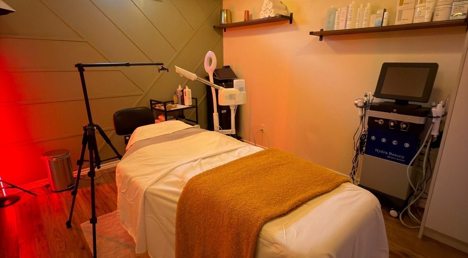 A relaxing treatment room at LAYORA AESTHETICS, Toronto, Ontario, CA, featuring a massage bed and beauty equipment.