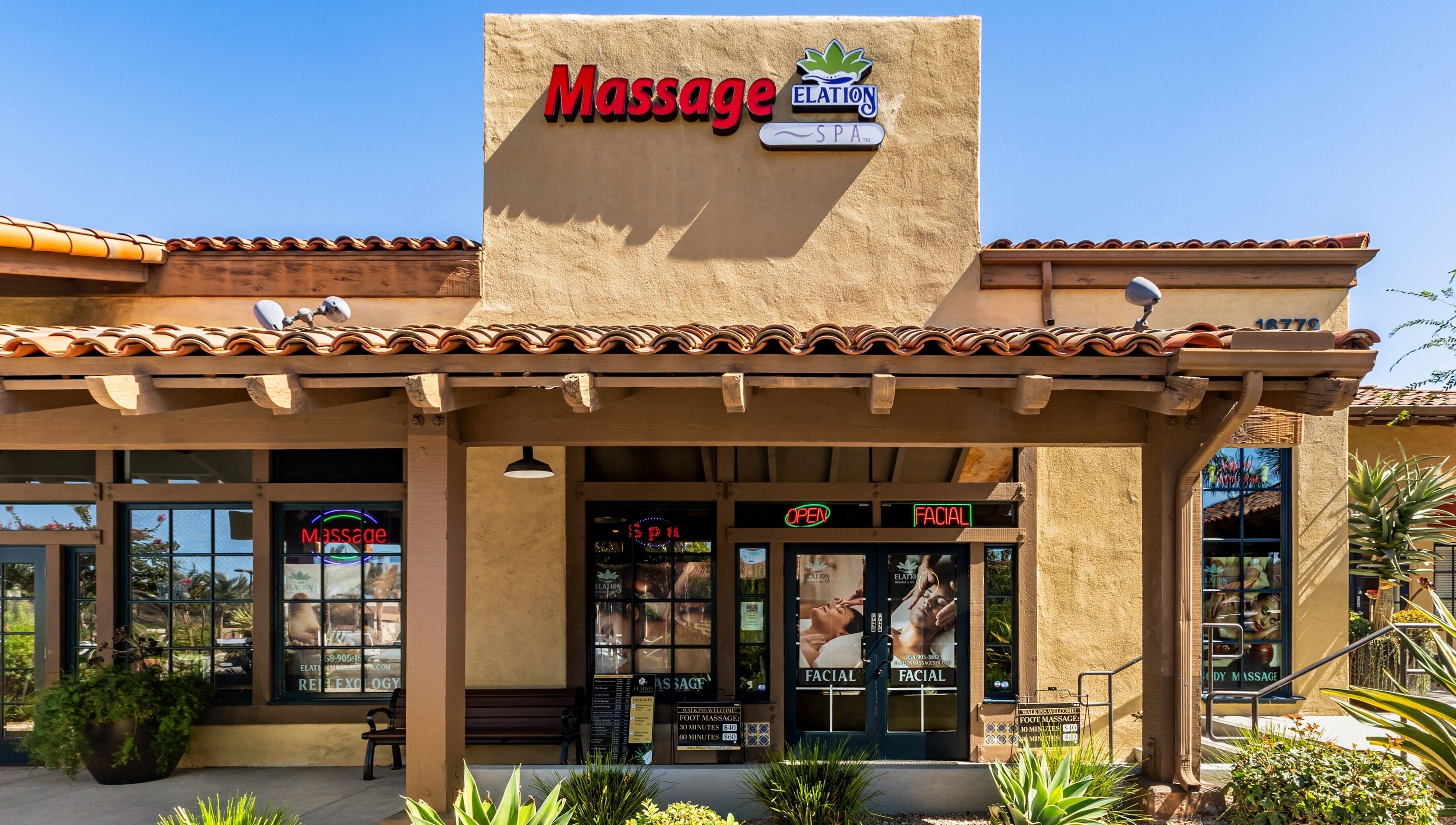 Front entrance of Elation Massage & Spa - San Diego in San Diego, California, US, with welcoming signs.