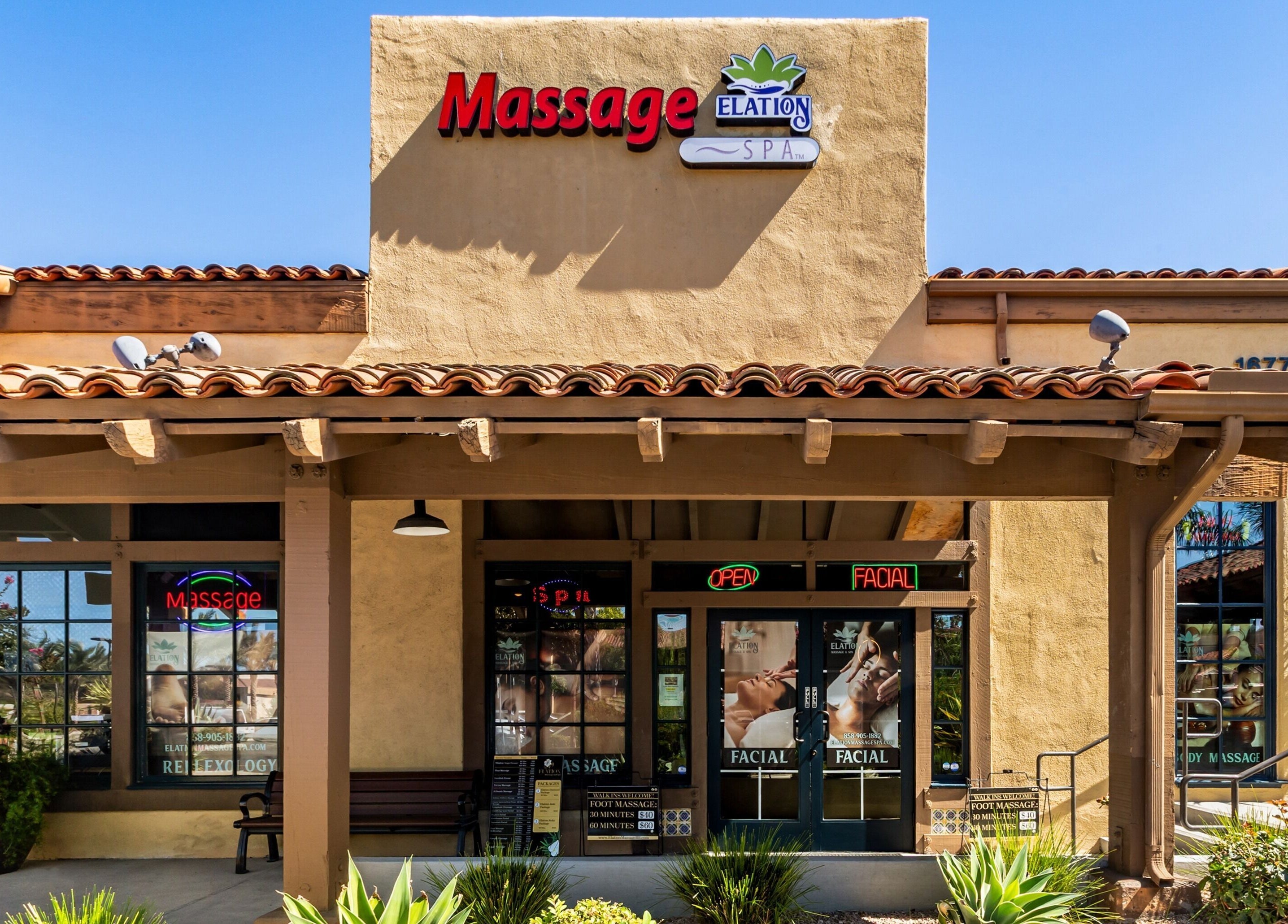 Front entrance of Elation Massage & Spa - San Diego in San Diego, California, US, with welcoming signs.