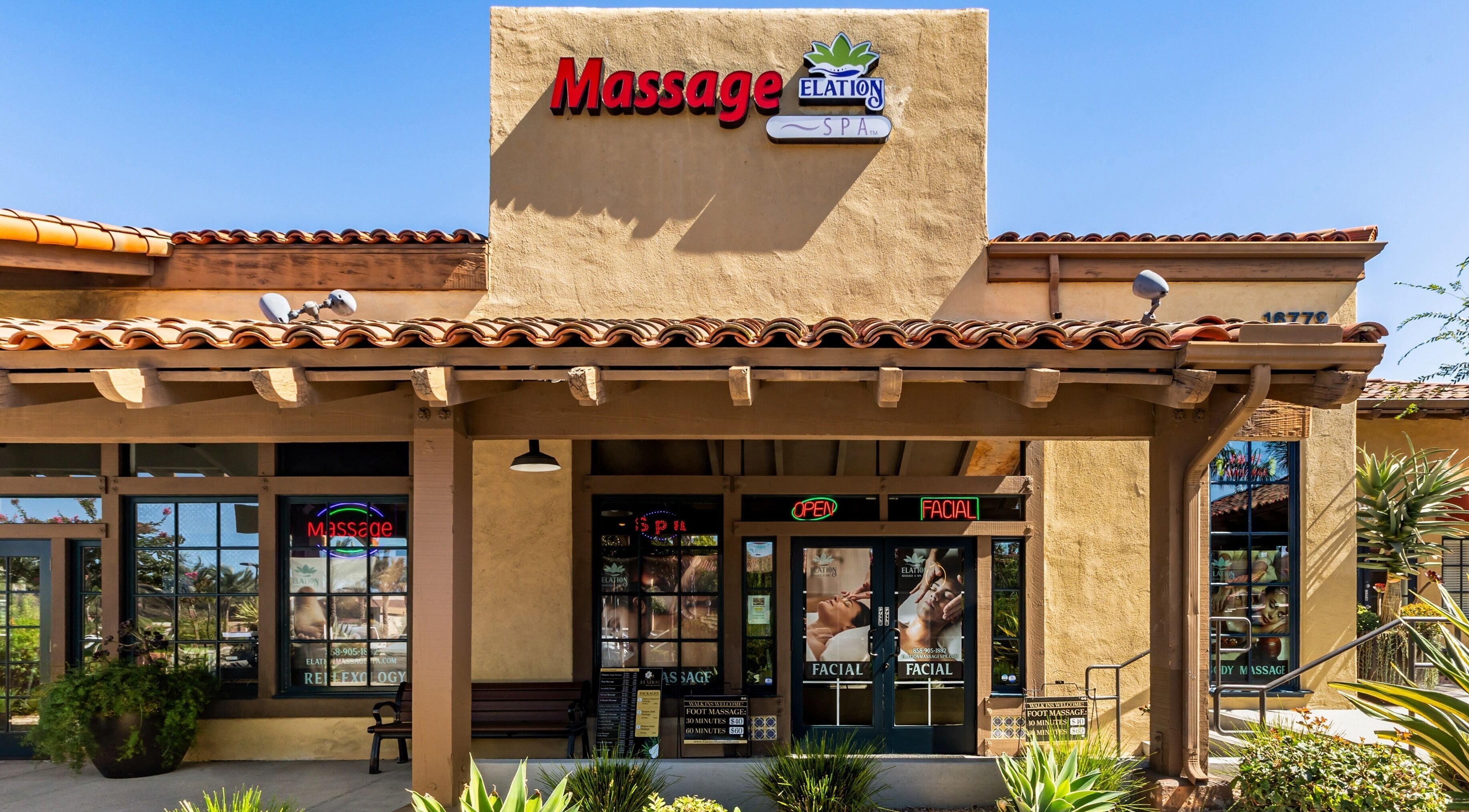 Front entrance of Elation Massage & Spa - San Diego in San Diego, California, US, with welcoming signs.