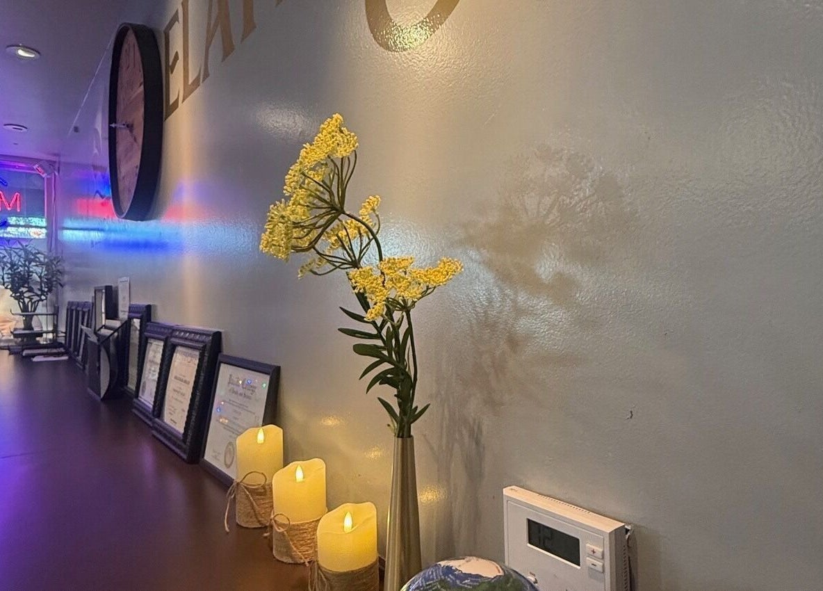 Decorative wall with flowers and candles at Elation Massage & Spa - San Diego, California, US.