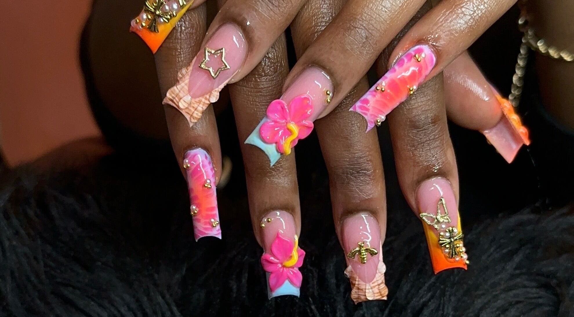 Detailed floral nail art at Narasdreamhouse, London, England, GB showcasing vibrant designs and embellishments.