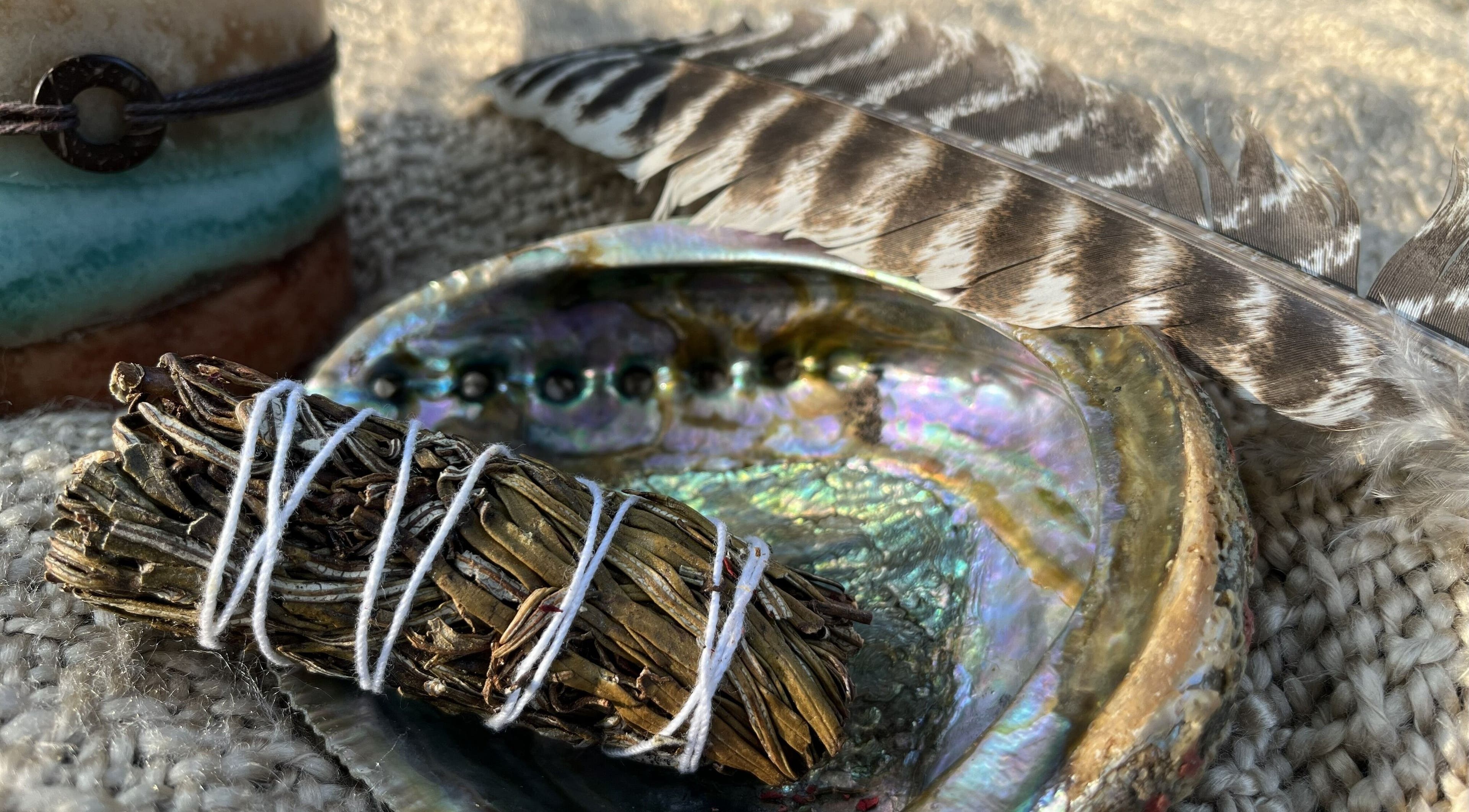 Arise Alight Healing Arts offers a sage bundle, abalone shell, and feather for healing rituals in Adrian, Michigan, US.