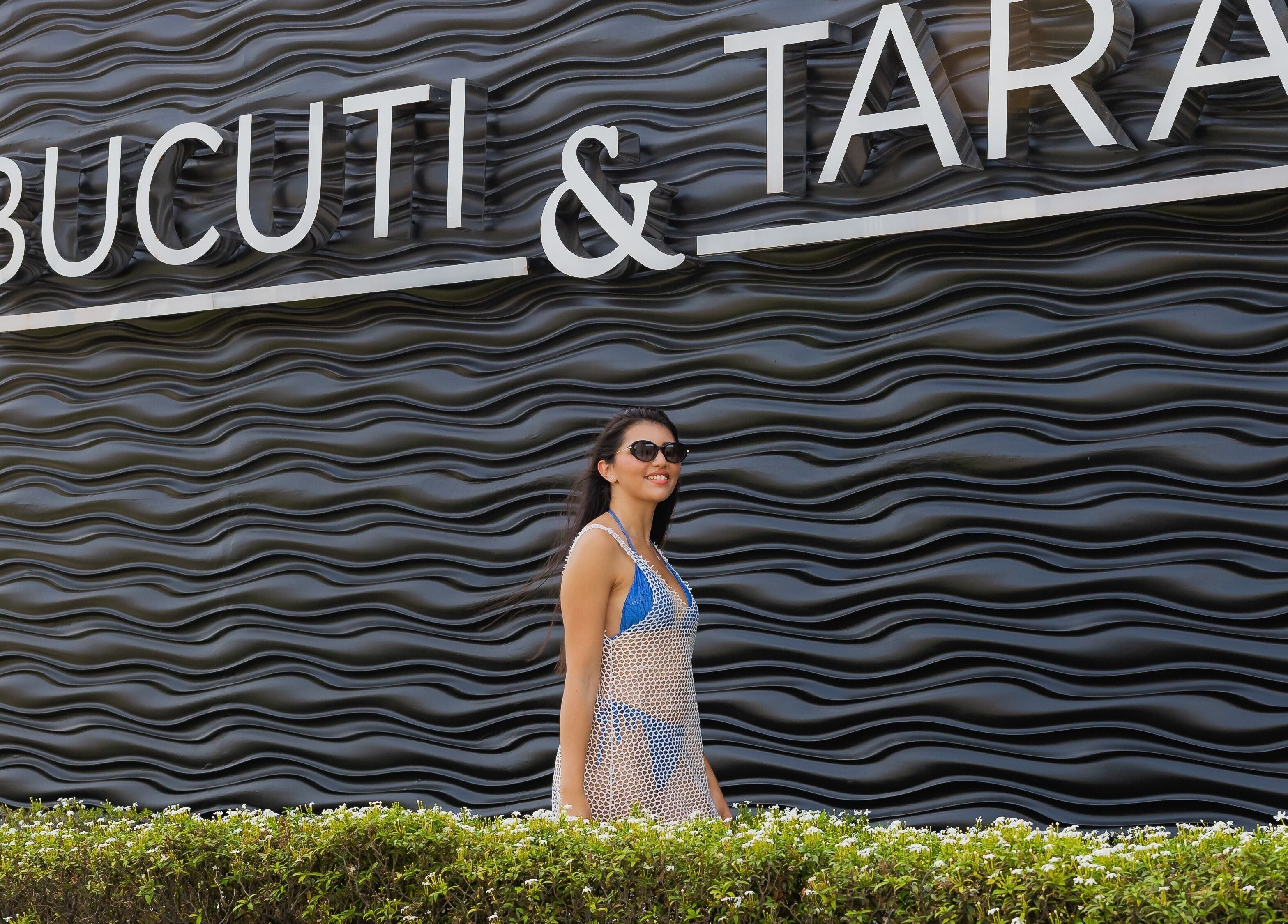 Visitor at Purun Spa's stylish exterior in Eagle, AW, near lush greenery.