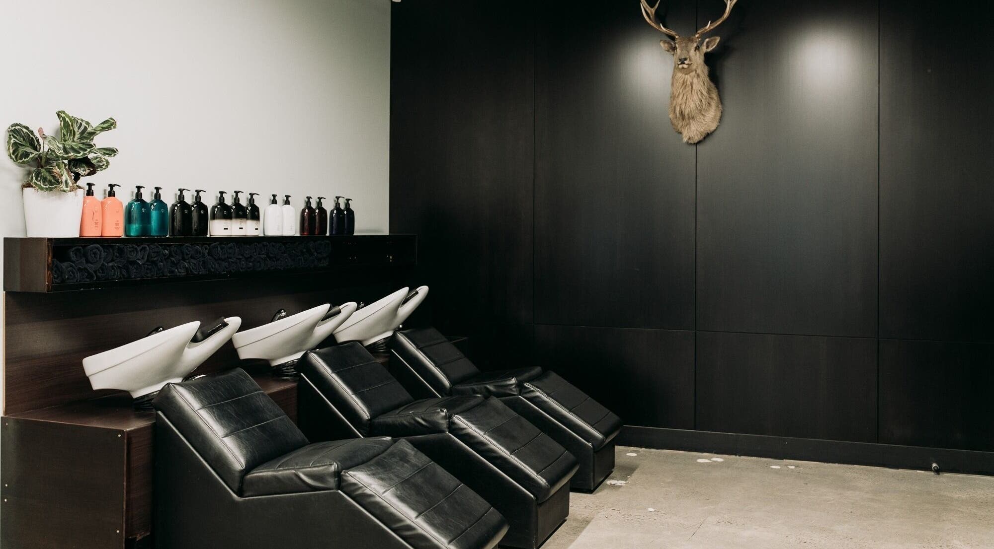 Elegant salon wash stations at Sable in Wellington, Wellington Region, NZ with modern black chairs and decor.