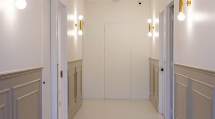 Elegant hallway at Glow Aesthetics Collective, Ingle Farm, South Australia, AU with modern light fixtures.