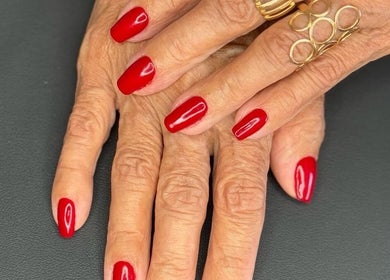 Elegant red manicure at Karina Figueiredo, Brooklyn Park, South Australia, AU showcases refined nail art.