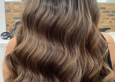 Elegant wavy hairstyle at Paula Amelia Hair Design, Penshurst, New South Wales, AU.
