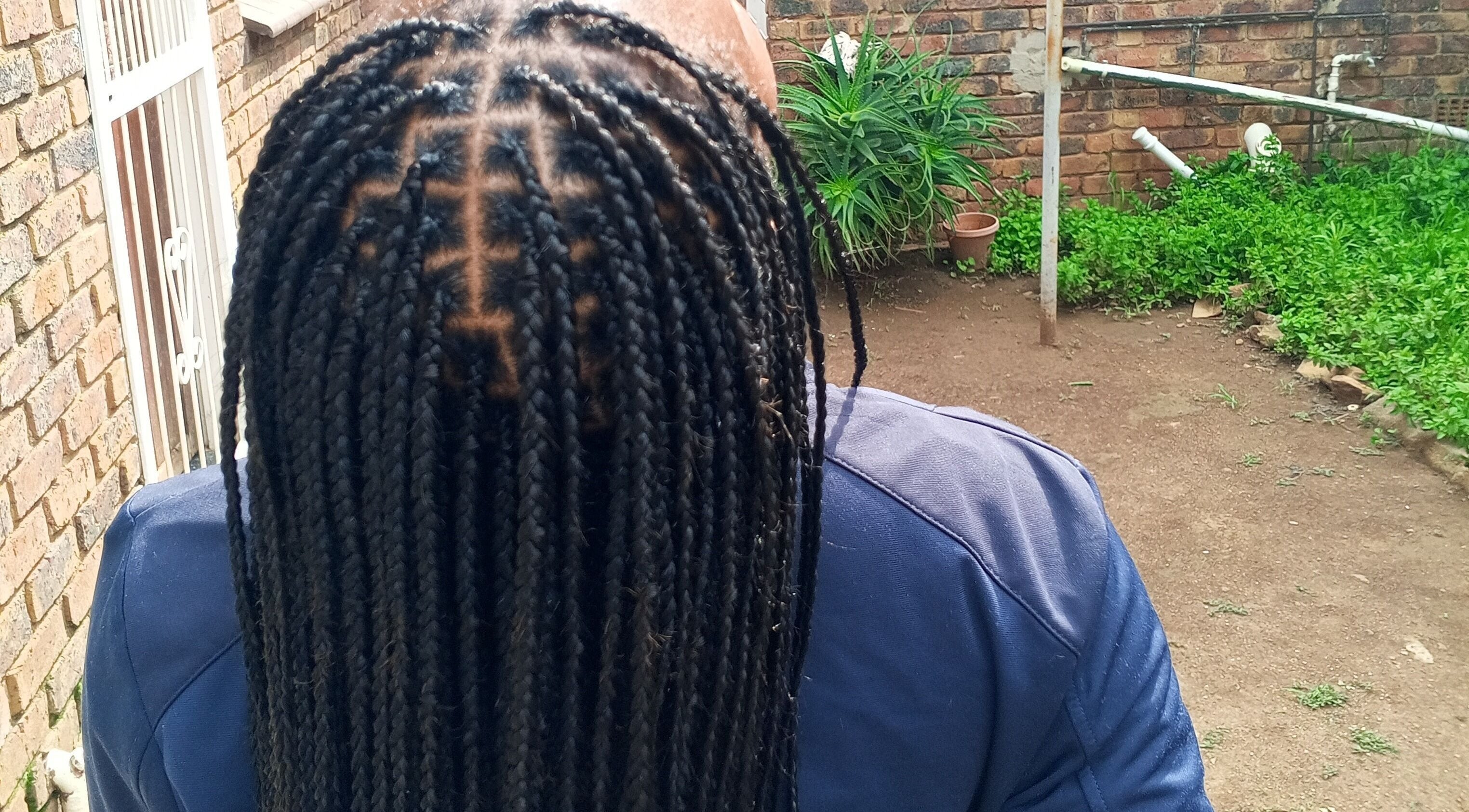 Neat braids showcased at House of Grace Beauty Salon, Johannesburg, Gauteng, ZA, highlighting expert styling.