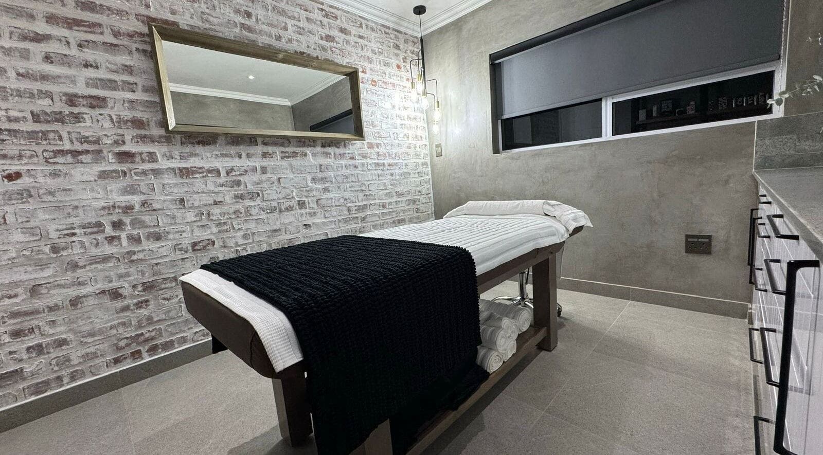 Modern treatment room at Defining Skin Studio, Pretoria, Gauteng, ZA with cozy table and minimalist decor.