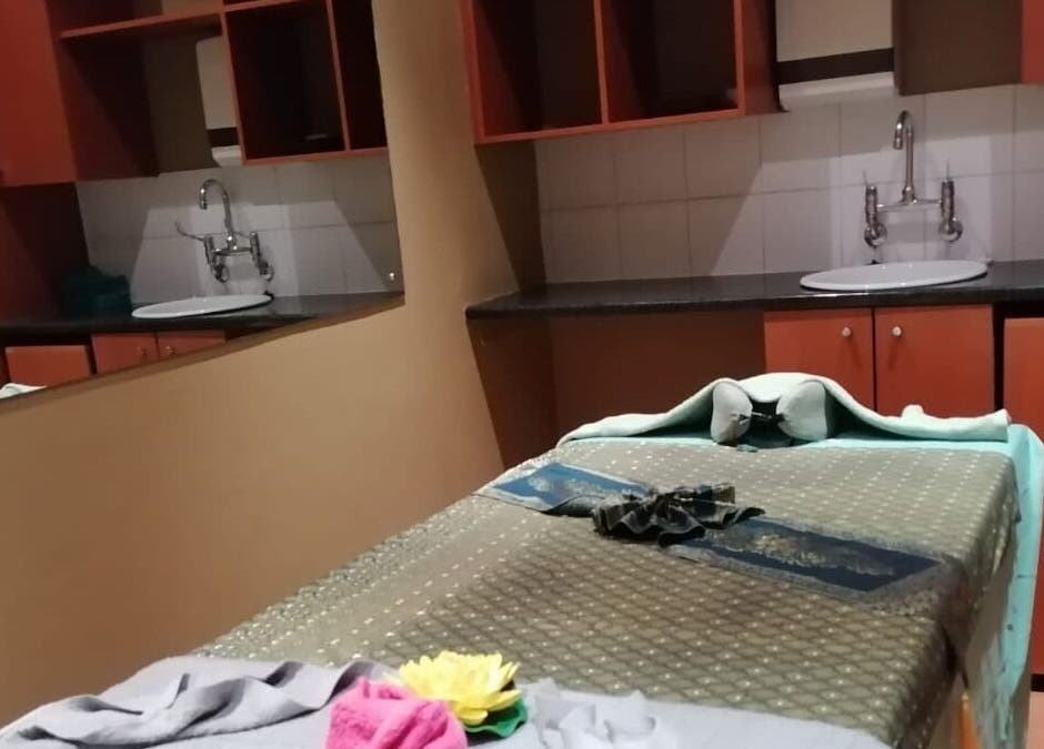 Massage room at Fadia Thai Massage in Cape Town, Western Cape, ZA. Tranquil ambiance with a massage table and sink.