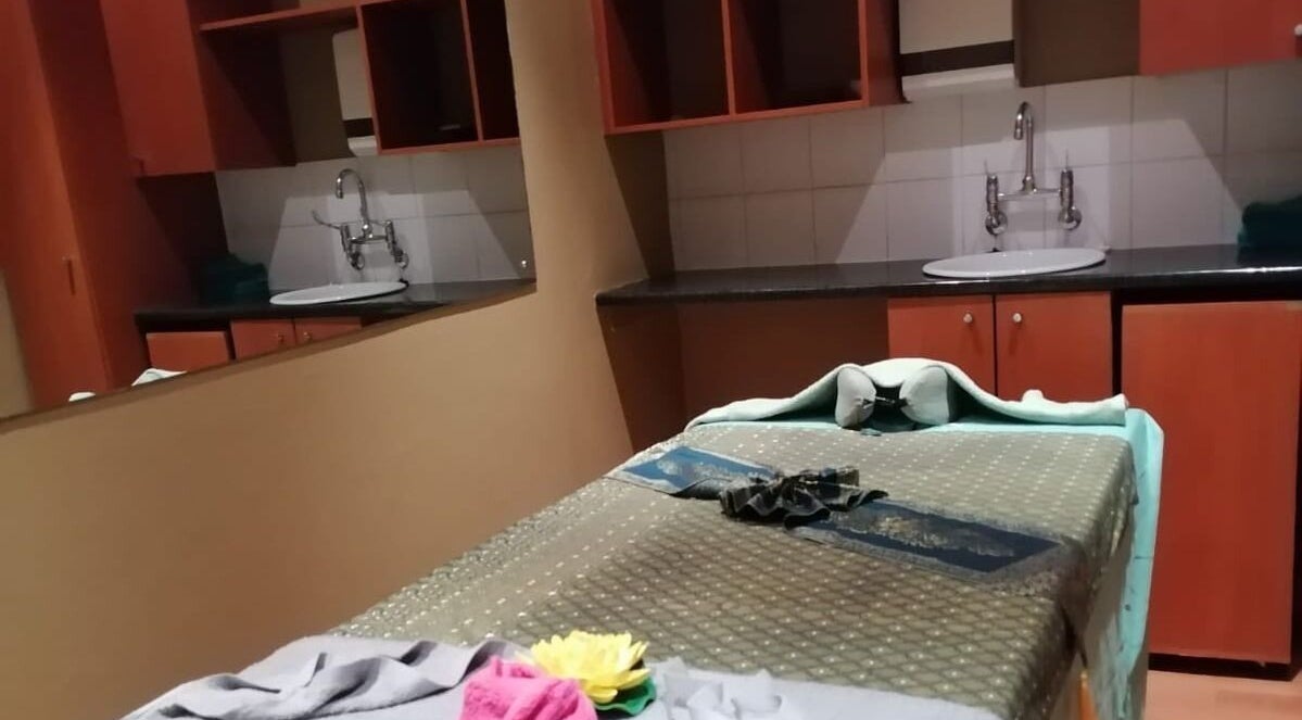 Massage room at Fadia Thai Massage in Cape Town, Western Cape, ZA. Tranquil ambiance with a massage table and sink.