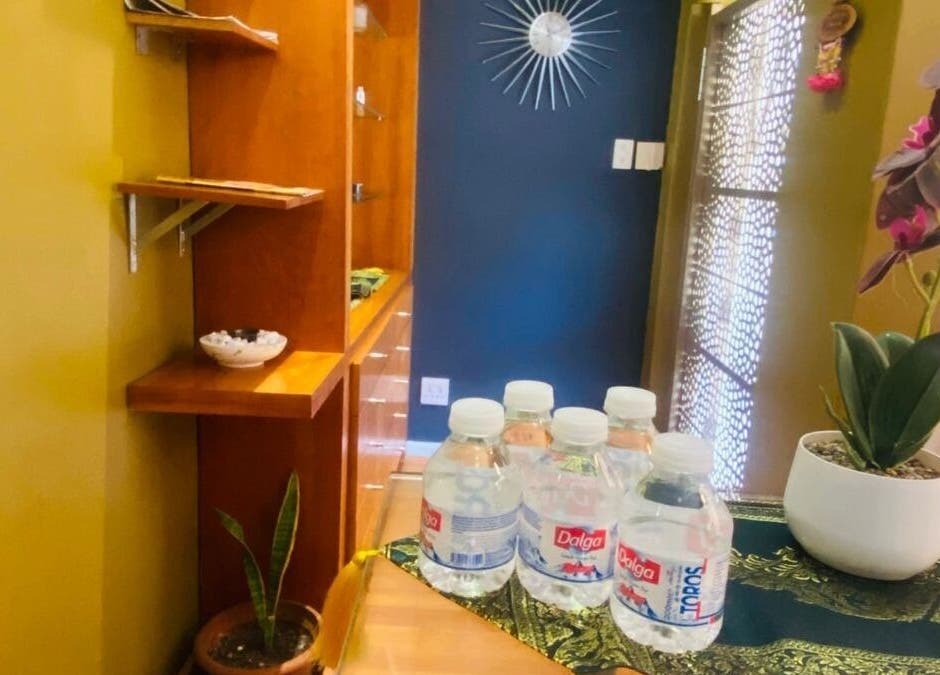 Entrance of Fadia Thai Massage in Cape Town, Western Cape, ZA with decor and complimentary water bottles.