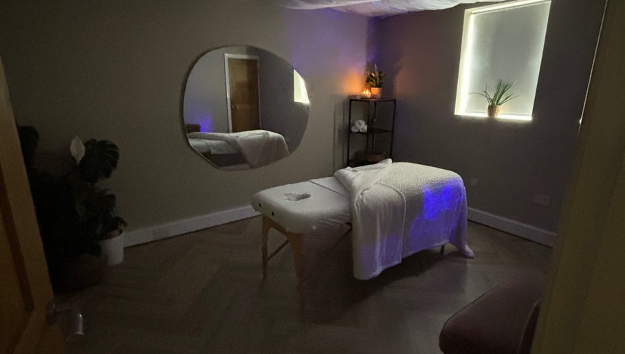 Tranquil massage room at Conscious Company, Stalybridge, England, GB with a cozy table and soothing decor.