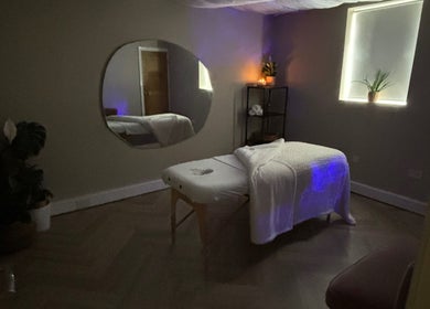 Tranquil massage room at Conscious Company, Stalybridge, England, GB with a cozy table and soothing decor.