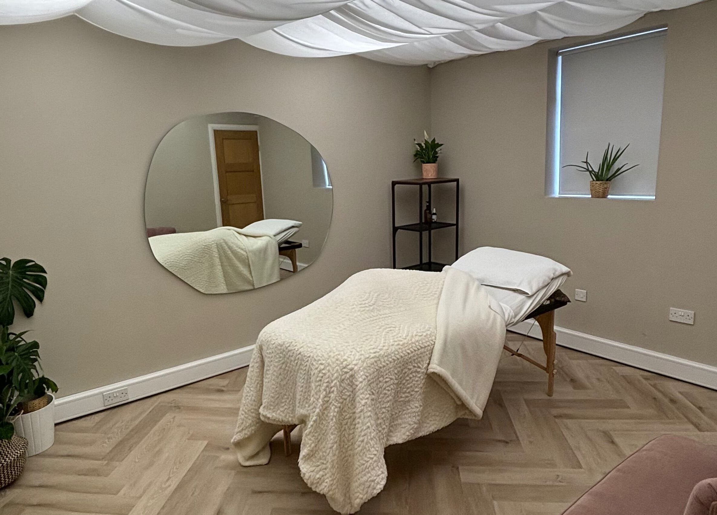 Peaceful therapy room at Conscious Company, Stalybridge, England, GB, featuring cozy bed and indoor plants.