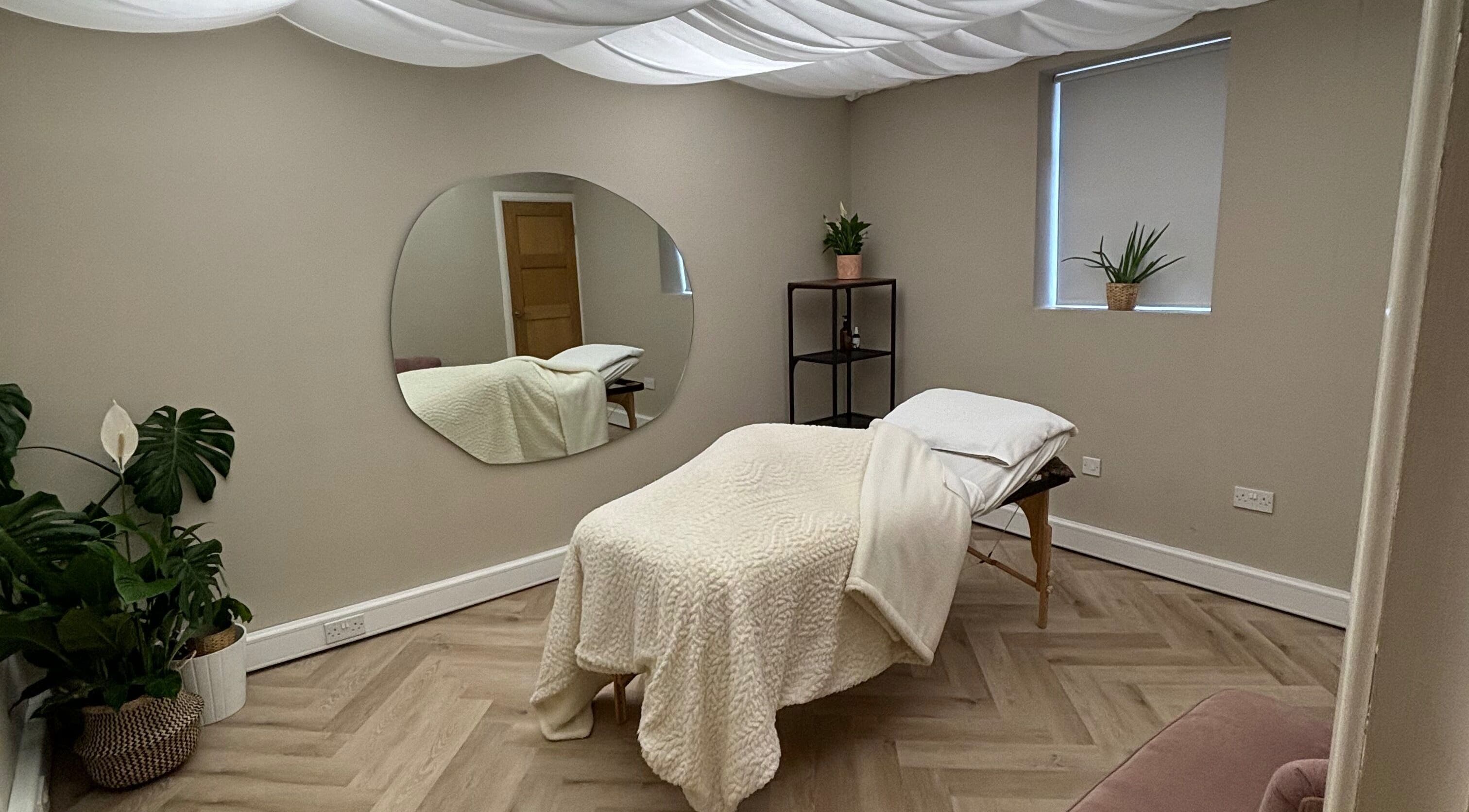 Peaceful therapy room at Conscious Company, Stalybridge, England, GB, featuring cozy bed and indoor plants.
