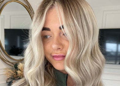 Elegant blonde hair styled at Indy Blonde Hair, Robina, Queensland, AU with soft waves and a polished finish.