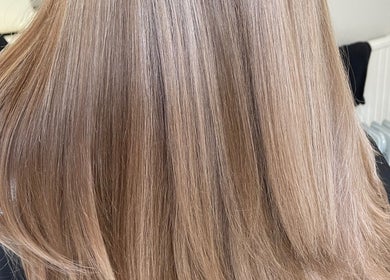 Smooth blonde hair styled at Indy Blonde Hair, Robina, Queensland, AU, showcasing a sleek, shiny finish.