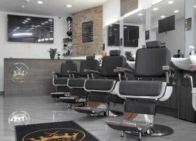 Chic interior of The Original Golden Barbers Ltd in London, England, showcasing modern barber chairs and decor.