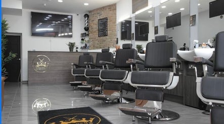 Chic interior of The Original Golden Barbers Ltd in London, England, showcasing modern barber chairs and decor.