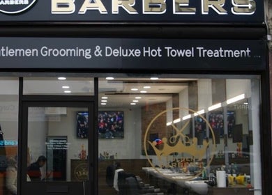 Entrance of The Original Golden Barbers Ltd in London, England, GB showcasing grooming services.