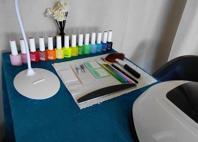 Colorful nail polish and tools at Nails By Shaaquila, Roodepoort, Gauteng, ZA, showcasing a vibrant display.