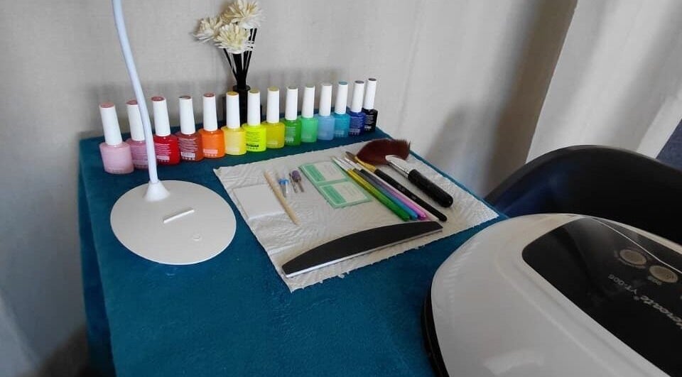 Nail polish selection at Nails By Shaaquila, Roodepoort, Gauteng, ZA, showcasing a vibrant workspace.