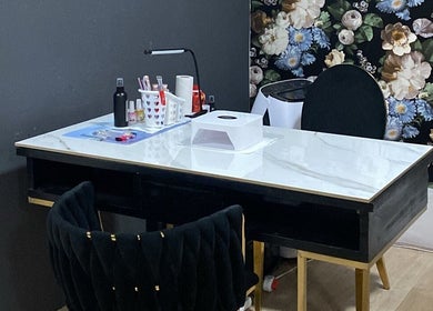 Sophisticated manicure station at Top Coated Lounge in Somerset West, Western Cape, ZA, featuring a floral backdrop.